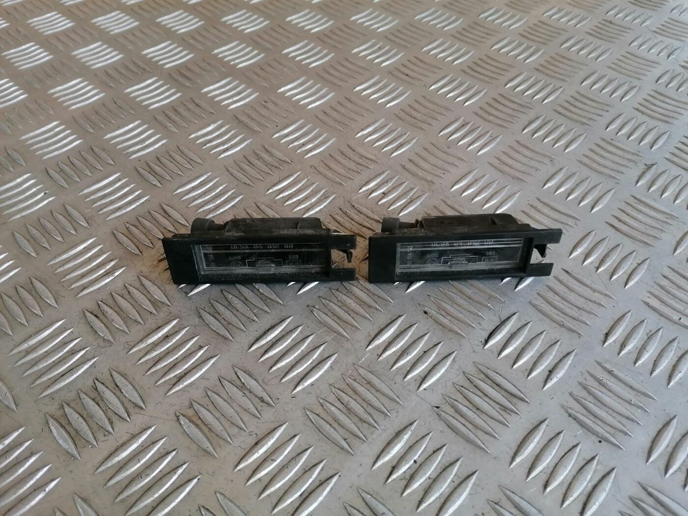 Numura zīmes apgaismojums priekš OPEL MERIVA 2004 1 Numura zīmes apgaismojums priekš OPEL MERIVA 2004